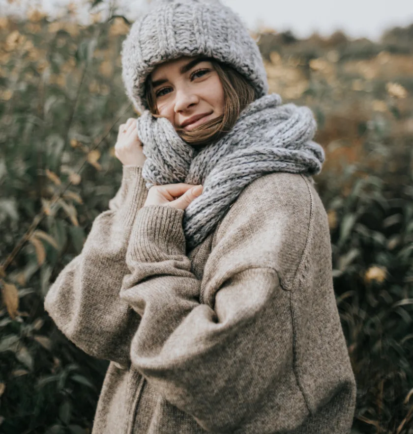 a woman wearing a hat and scarf