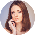 a woman with her hand on her face