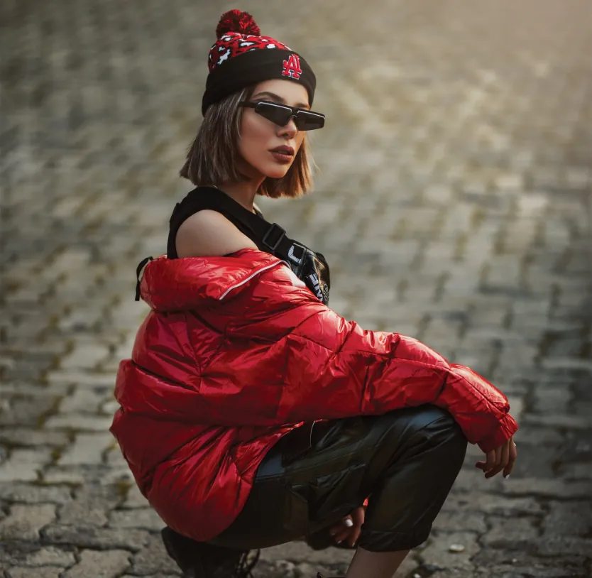 a woman squatting on a brick surface